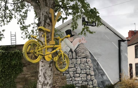 Yellow bike sign on a tree